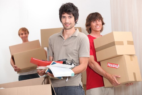Careful loading of household items for transport in Harlington