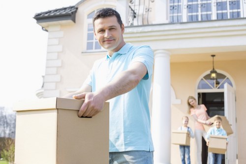 Movers carrying furniture through a narrow hallway