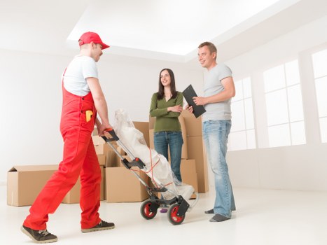 Packed office boxes and furniture ready for a Harlington commercial move