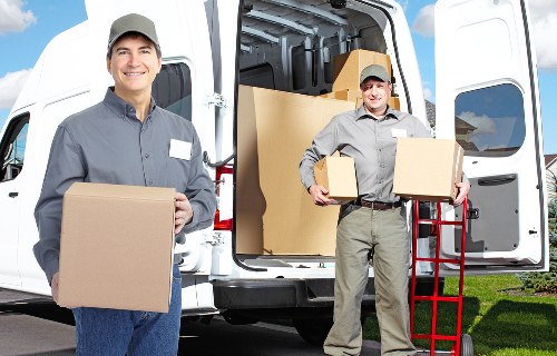 Local movers handling office equipment during a Harlington relocation